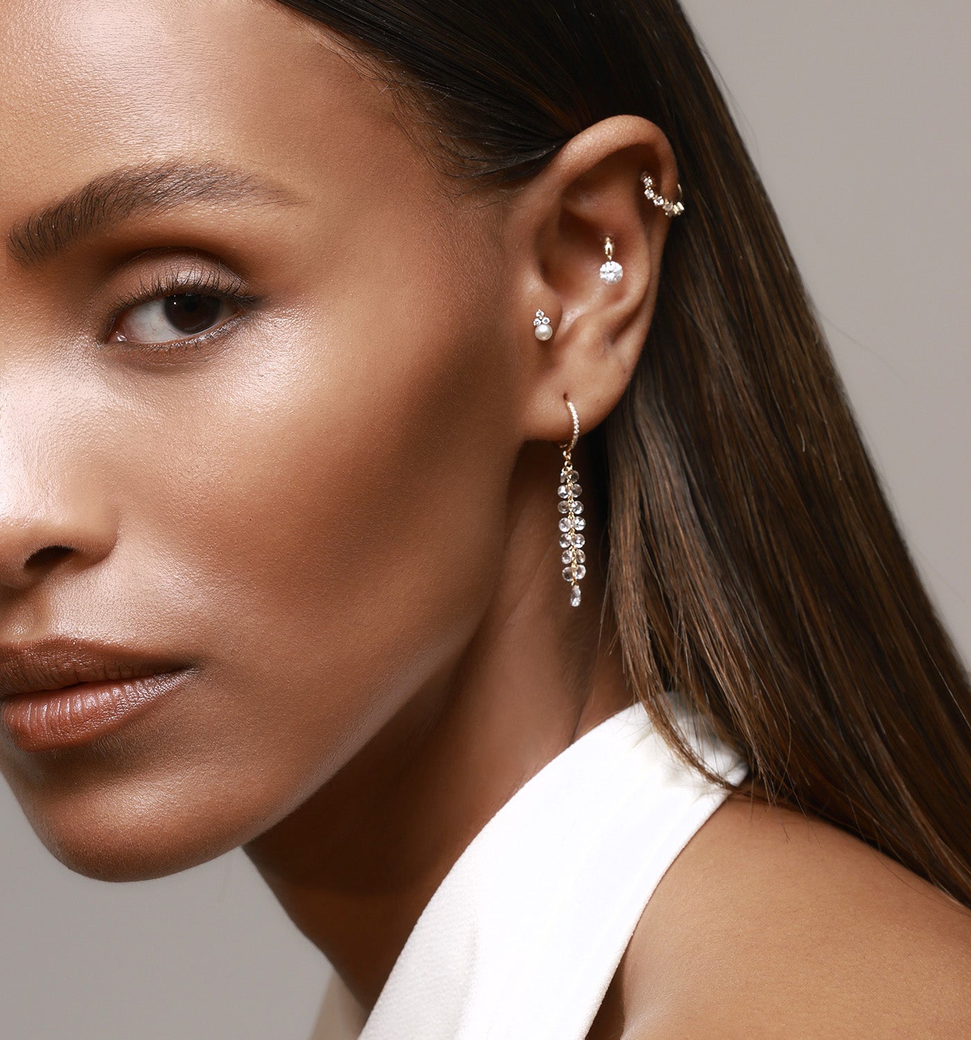 ALL SHINE HUGGIE hoop earring in rose gold set with natural diamonds worn on a model