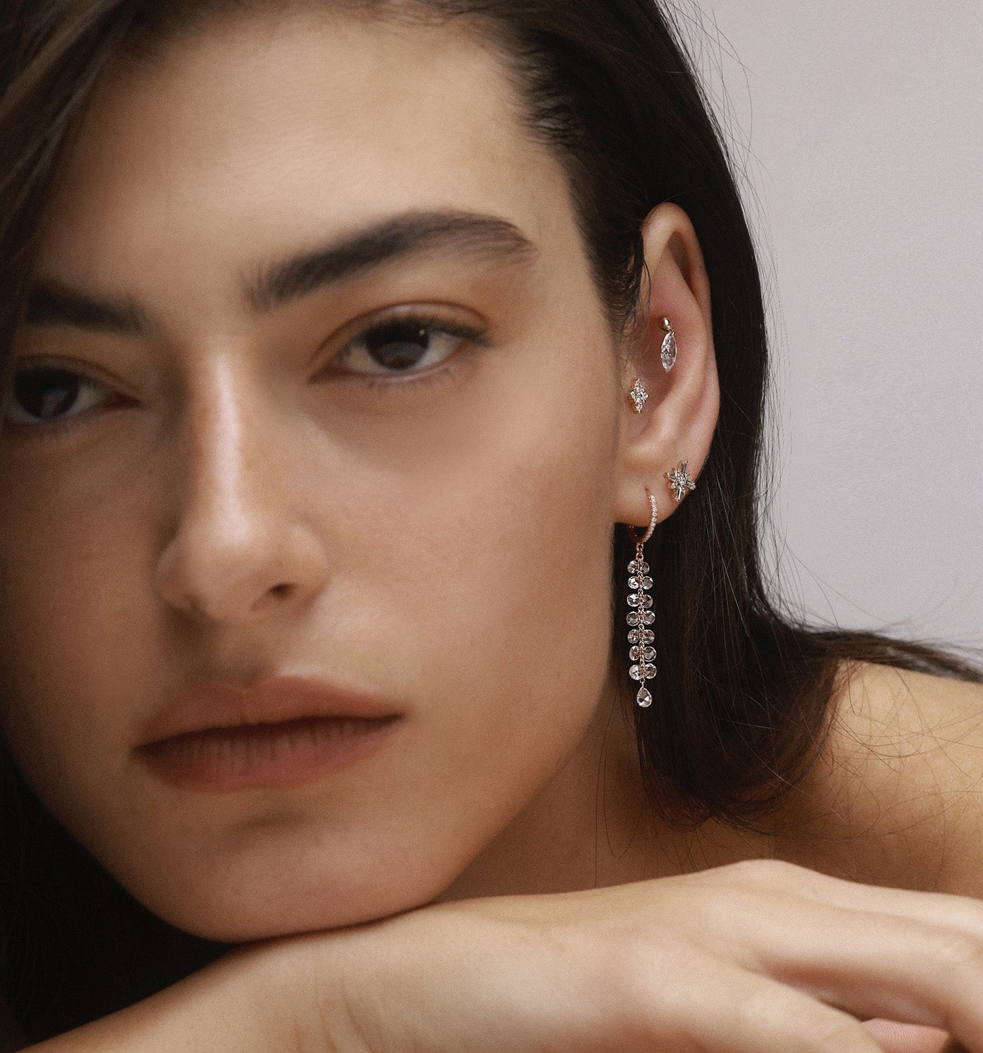 BRIGITTE EARRING hoop earring in yellow gold set with floating natural diamonds and floating natural rose cut diamonds worn on a model image 2