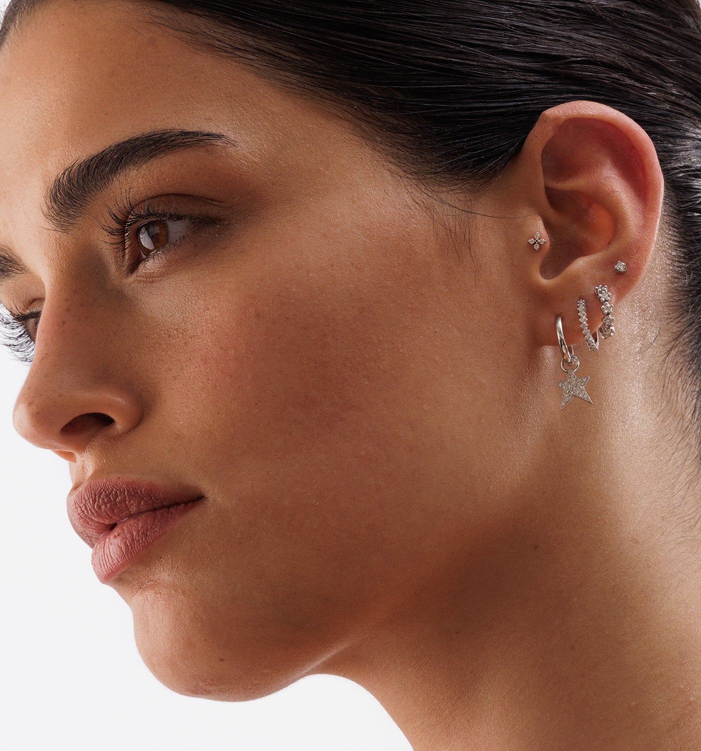 CROWN ROUND DIAMONDS HOOP 12mm hoop earring in white gold set with natural diamonds worn on a model second angle