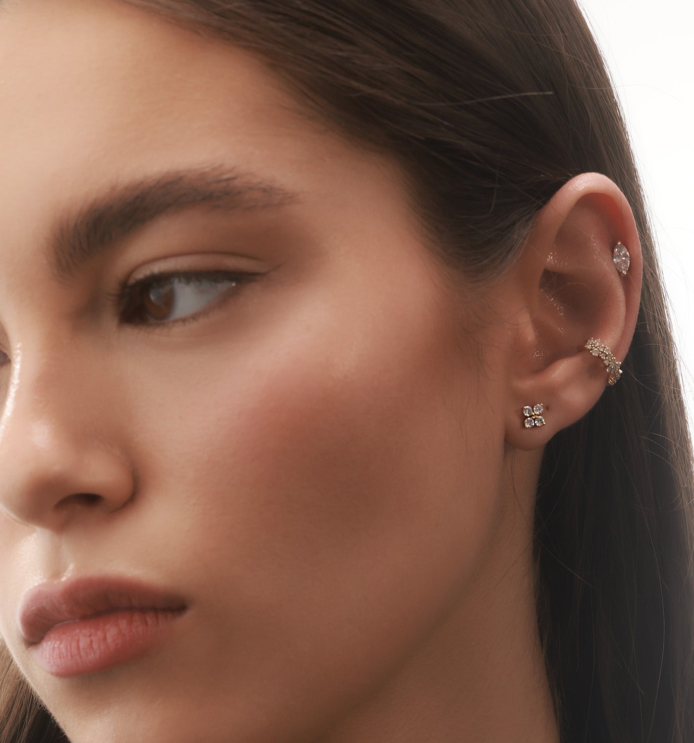 Four XL Diamonds stud earring in white gold set with natural diamonds worn on a model’s ear
