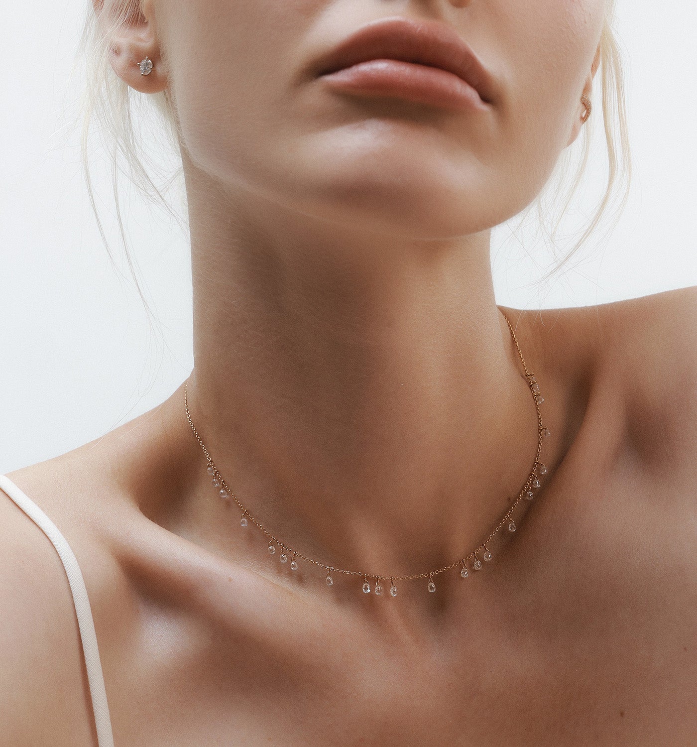 Luna necklace in rose gold with floating natural rose cut teardrop diamonds worn on a model’s neck