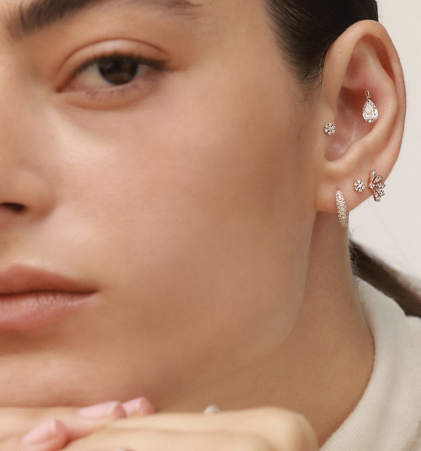 Vivi Diamonds stud earring in rose gold set with natural diamonds worn on a model’s ear