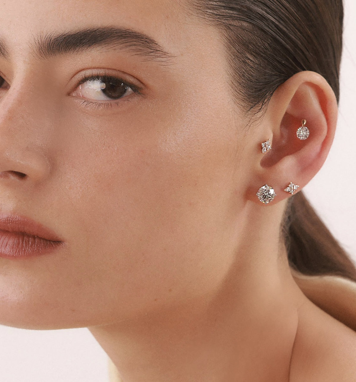 CVD lab diamond stud earrings 1.5 carat each set in white gold worn on a model’s ear
