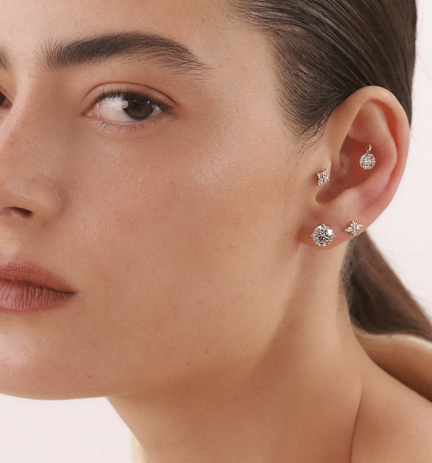 CVD lab diamond stud earrings 1.5 carat each set in white gold worn on a model’s ear