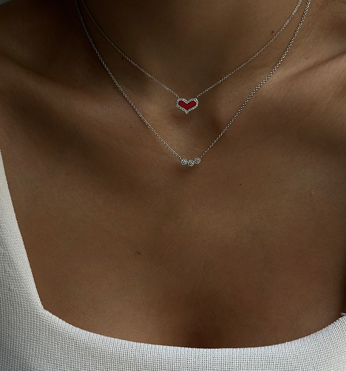 HEART DIAMONDS NECKLACE in white gold set with natural diamonds and red enamel worn on a model