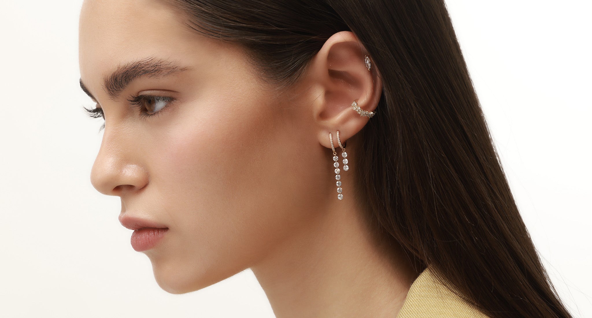 Melania seven floating diamonds hoop earring in yellow gold worn on a model horizontal view