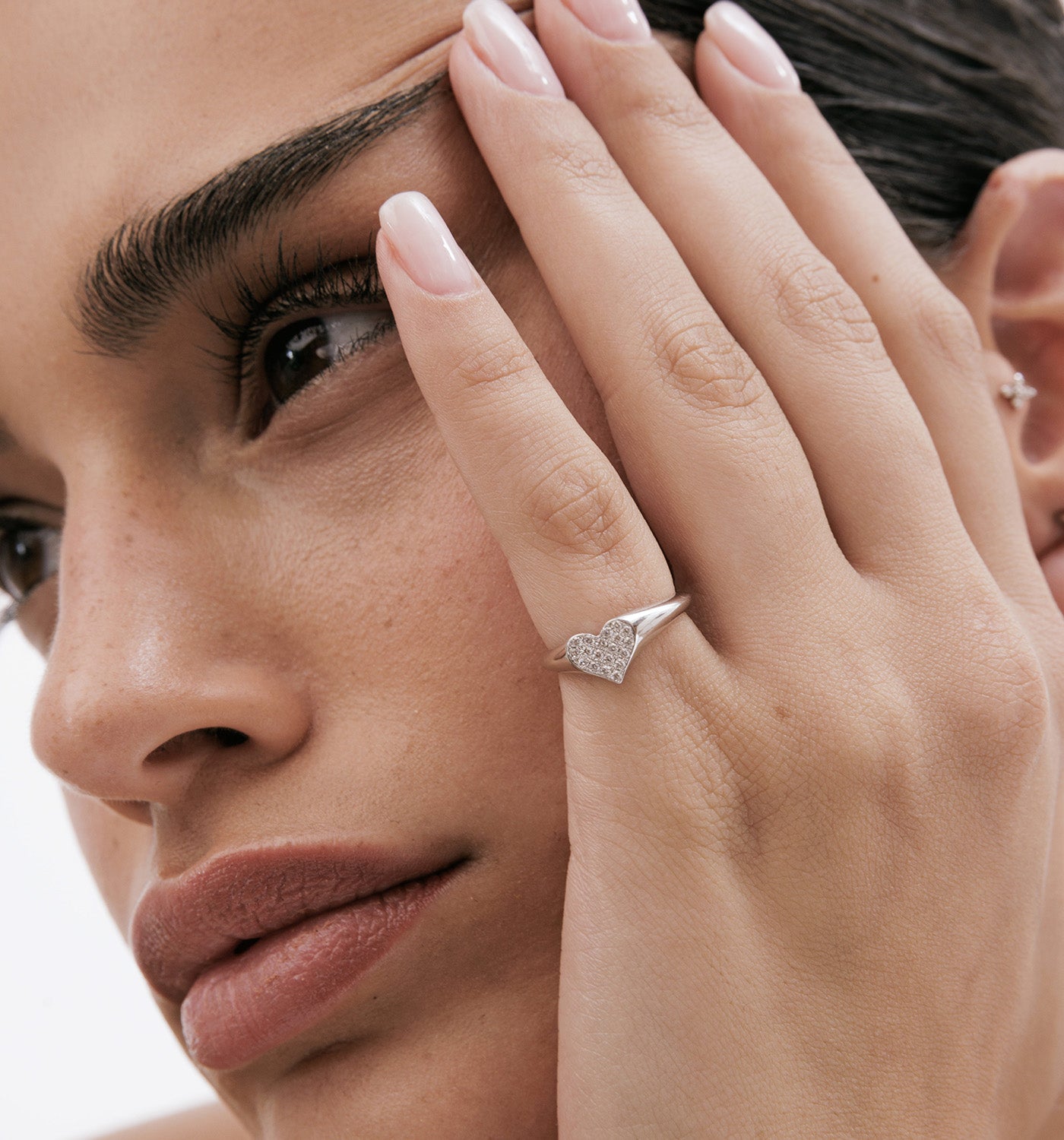 Pinky heart signet ring rose gold set with natural diamonds on model hand