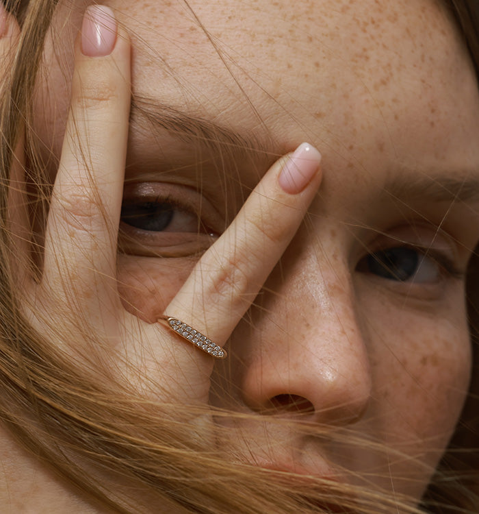 Victoria pinky signet ring in rose gold set with natural diamonds worn on a model hand second view