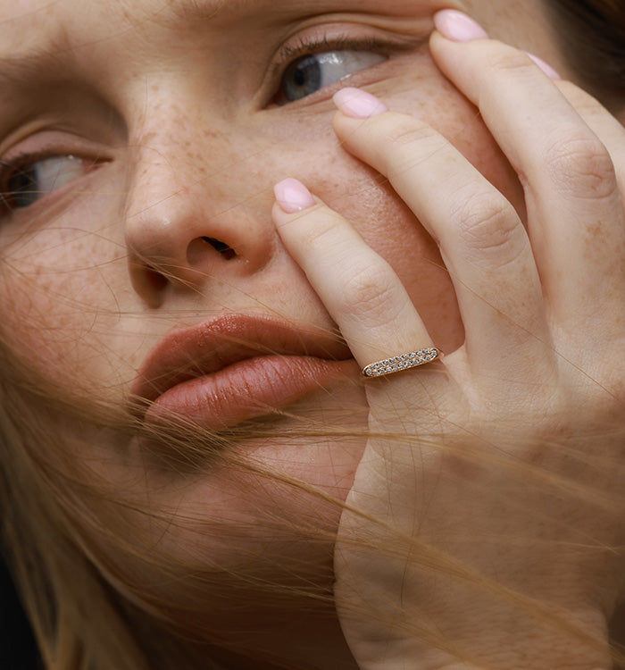 Victoria pinky signet ring in rose gold set with natural diamonds worn on a model hand second view